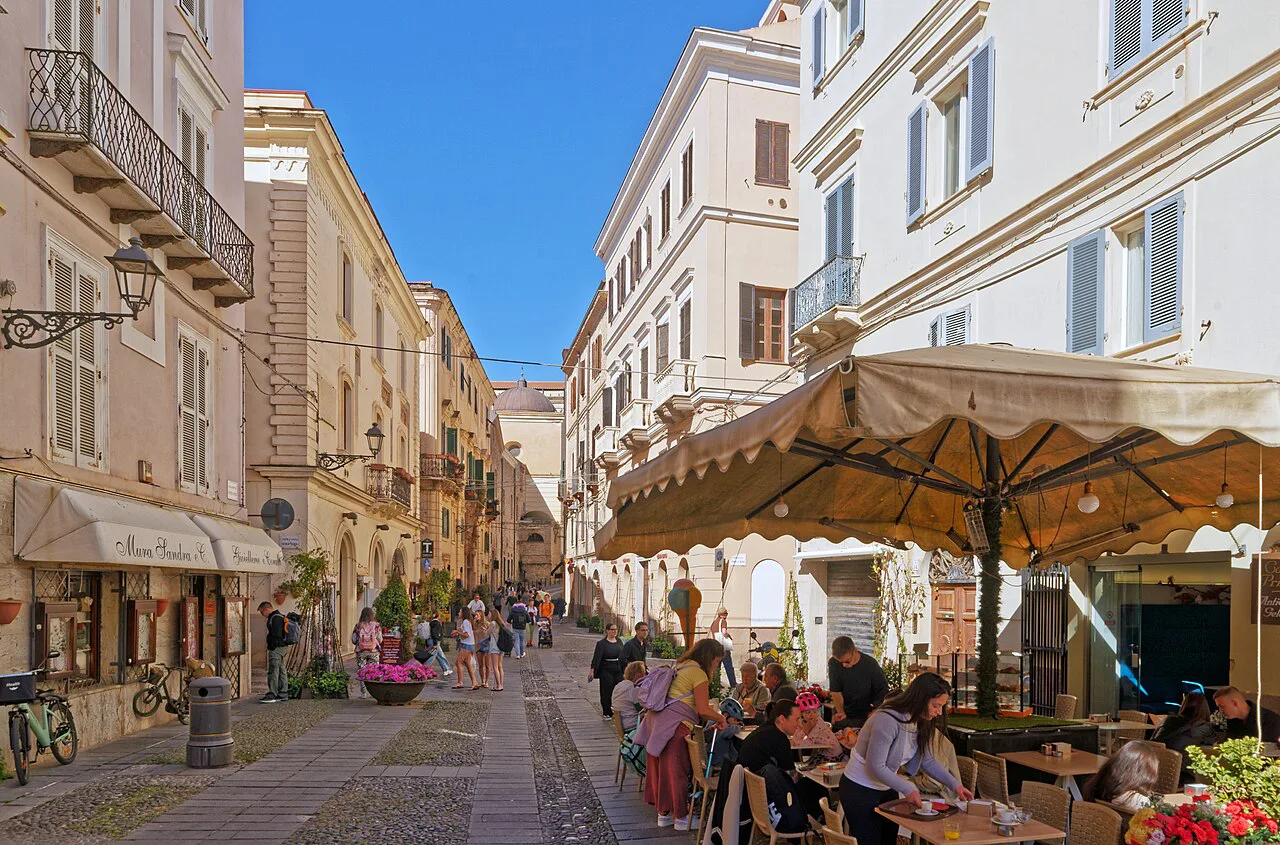 Street with restaurant tables in Alghero.