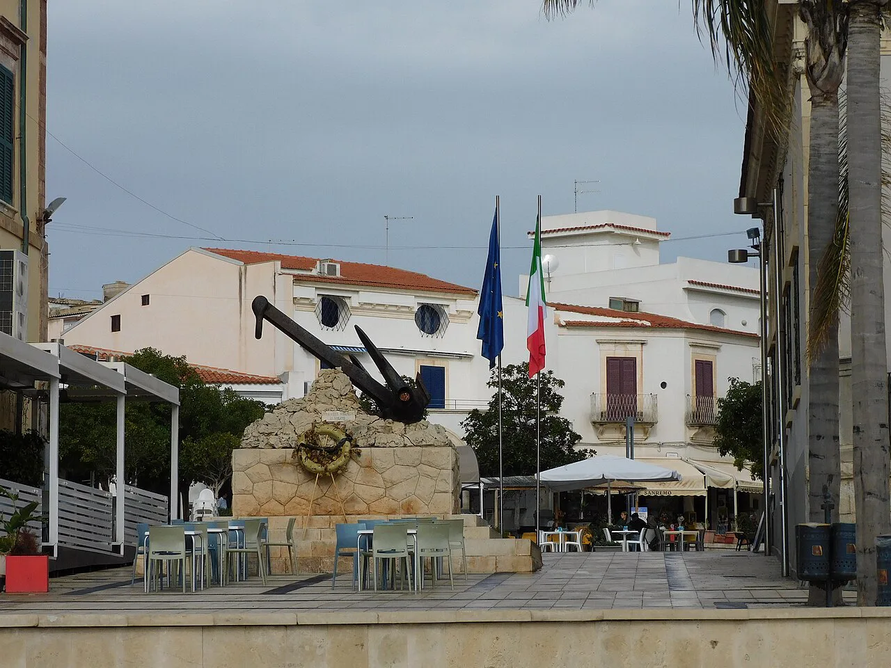 Seafront square at Marina di Ragusa with a memorial anchor.