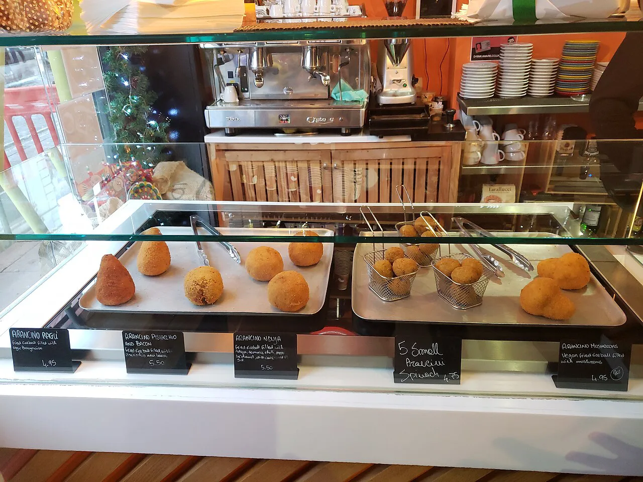 Arancini on display at a counter.