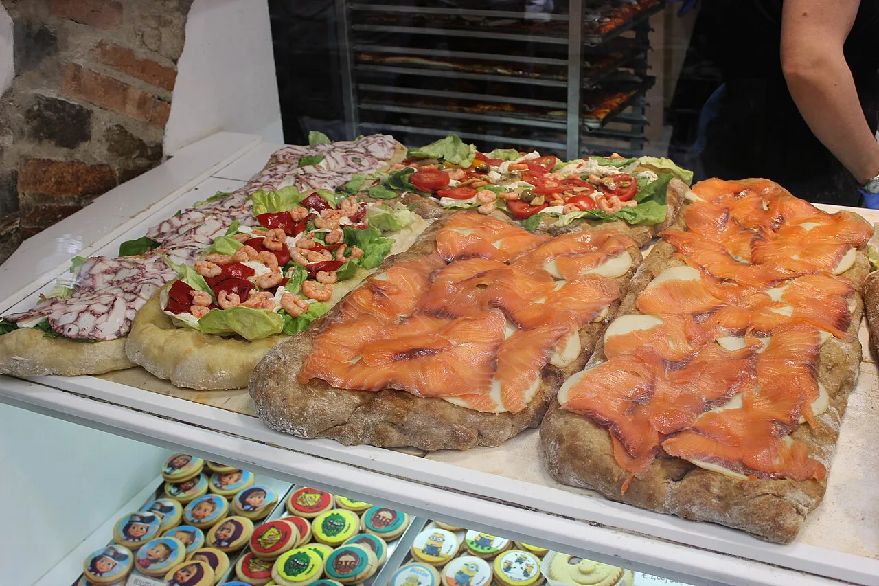 Focaccia with toppings at a Bergamo bakery.