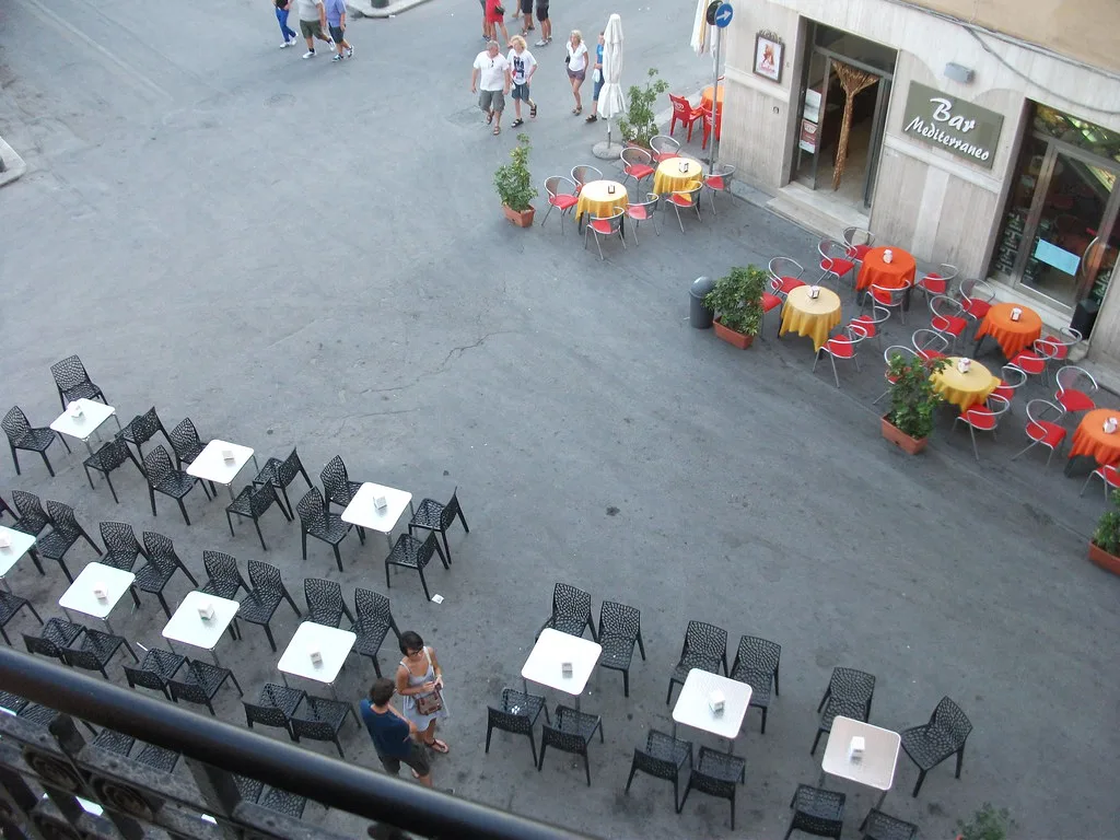 Café tables on a piazza in Trapani.