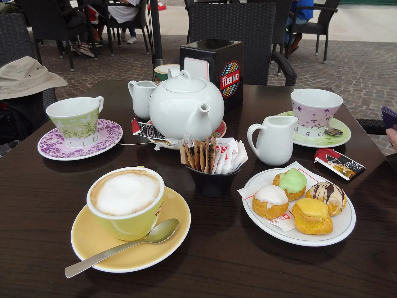 Pastries and tea at a cafe table in Verona.