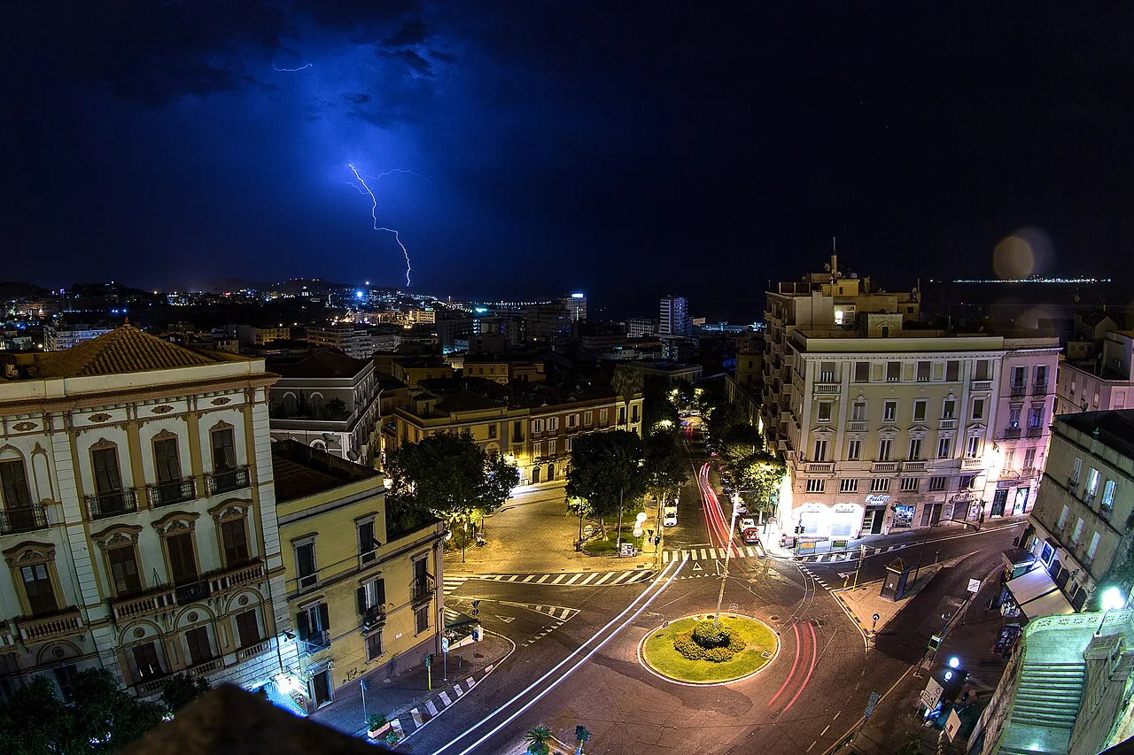 Piazza Costituzione in Cagliari at night.