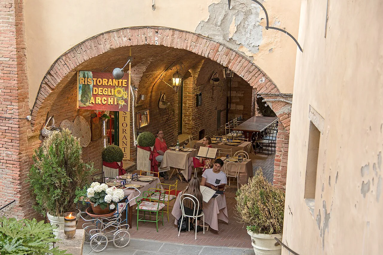 Restaurant terrace in a Montepulciano alley.