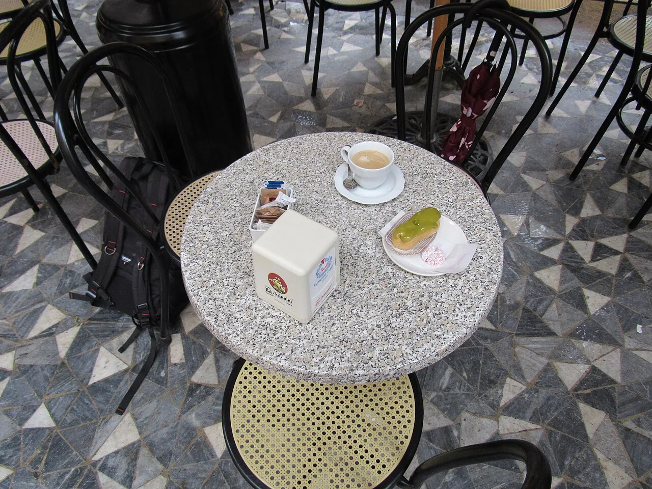 Café table with coffee and cake in Lucca.