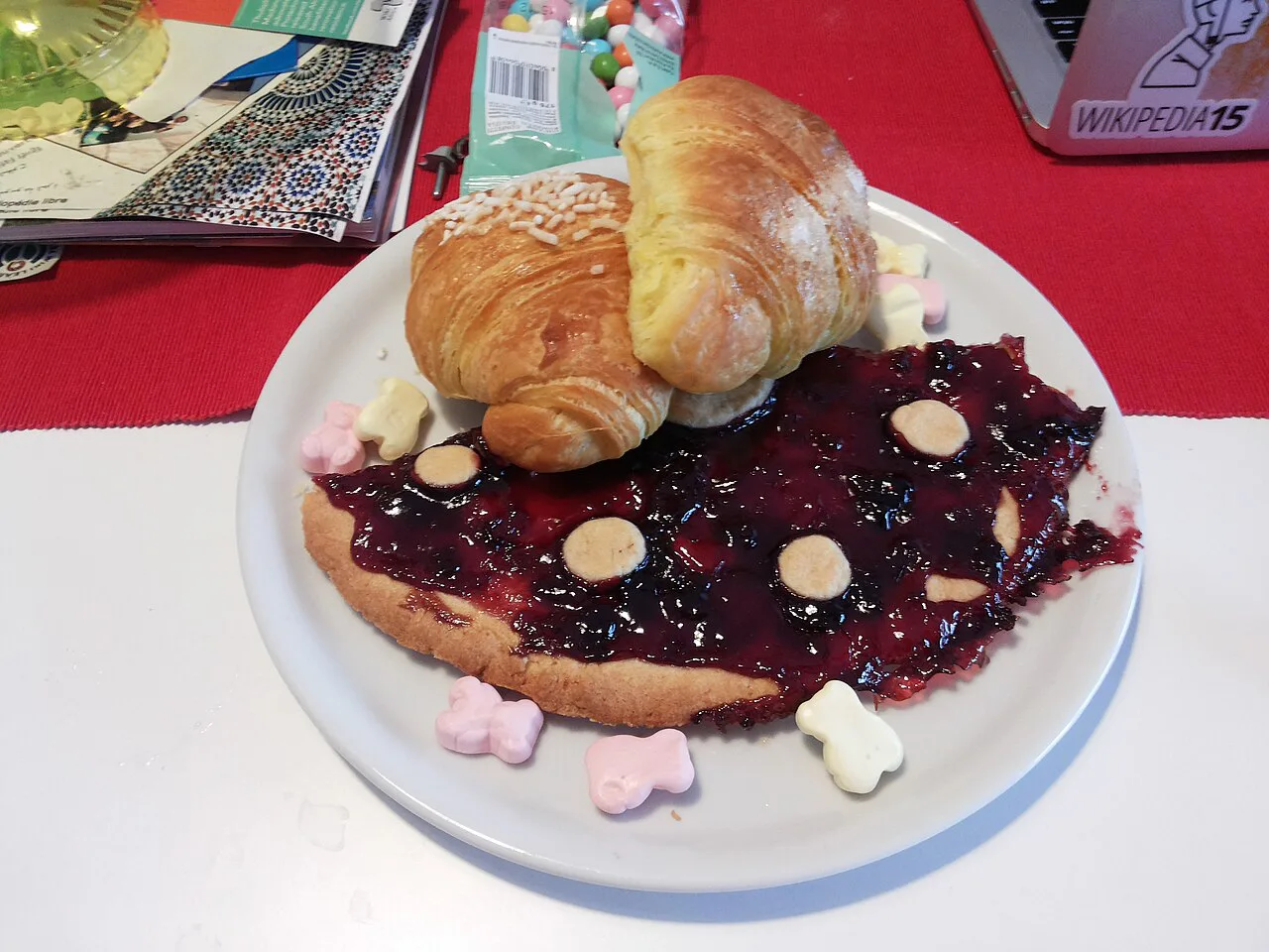 A breakfast of croissant, berry compote and jam.