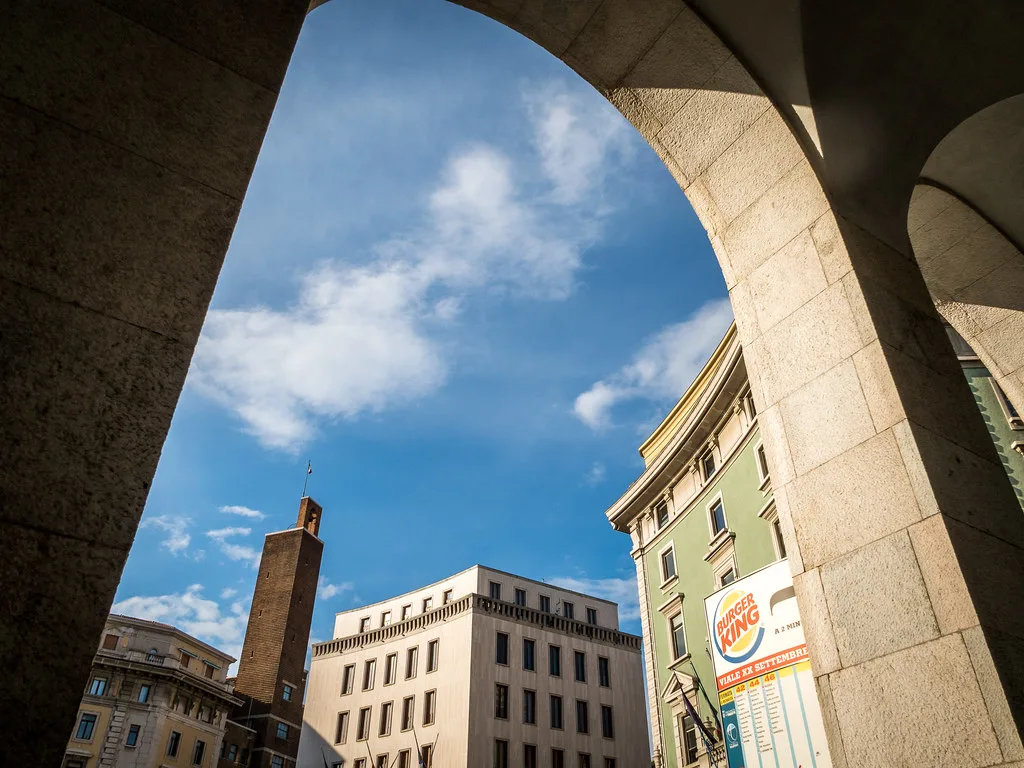 Arcade and rooftops in Trieste.