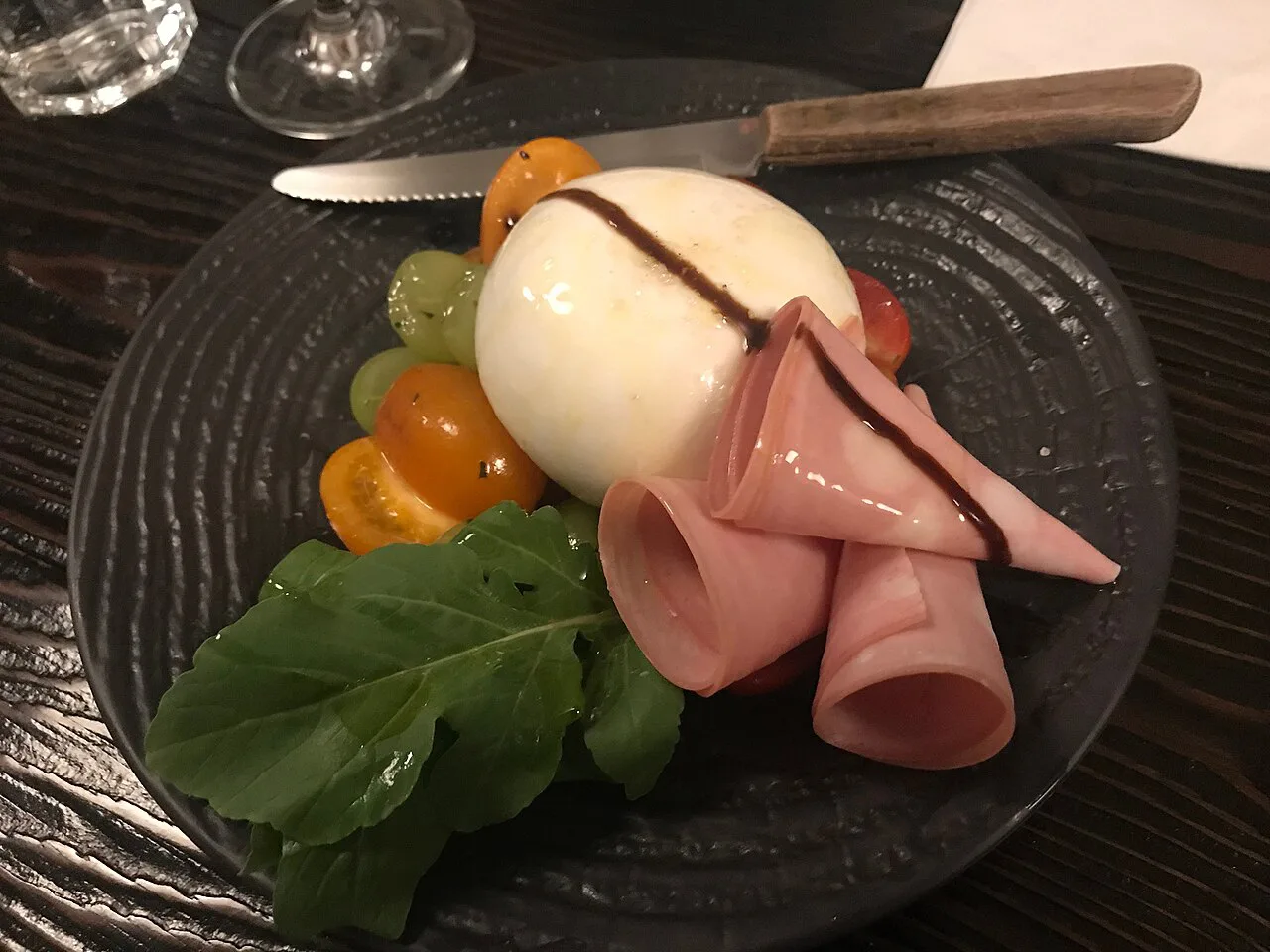 Burrata with ham, rocket and tomatoes.