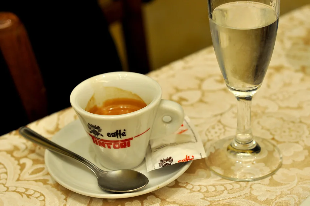 Espresso served with a glass of grappa.
