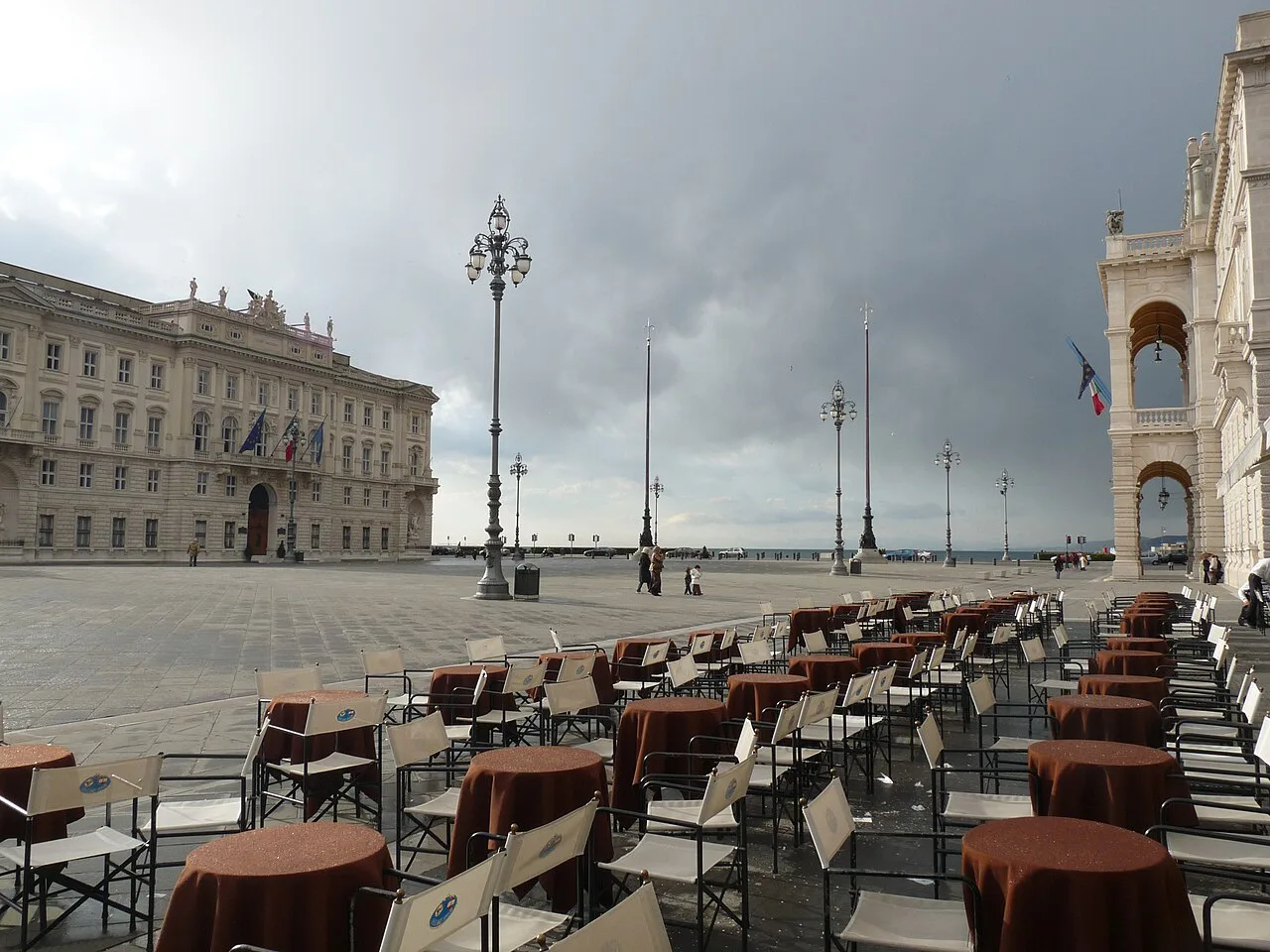 Café tables on Piazza Unità d'Italia in Trieste.
