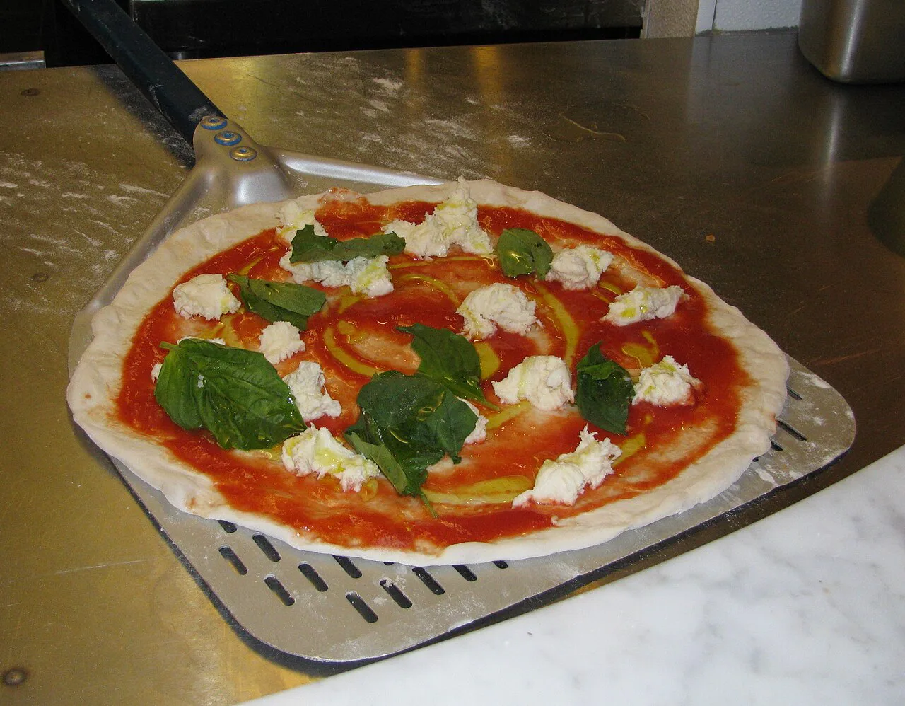 A Neapolitan pizza on a peel.