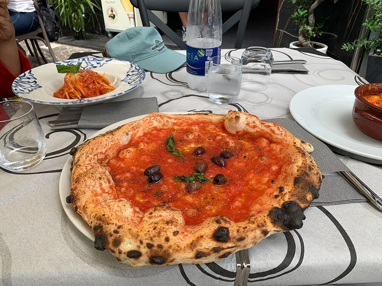 A Neapolitan pizza at a table in Pompeii.