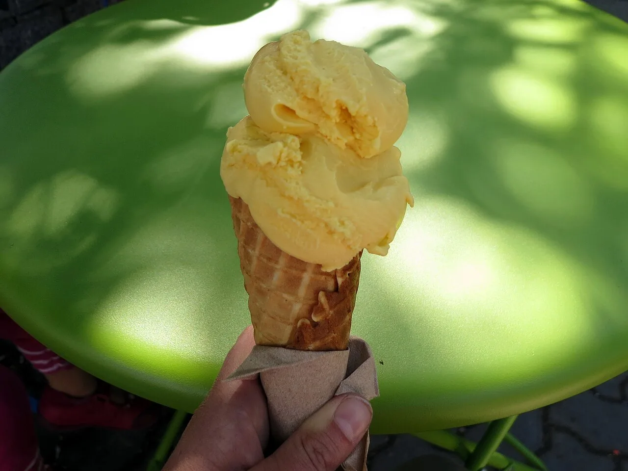 Mango gelato in a cone.