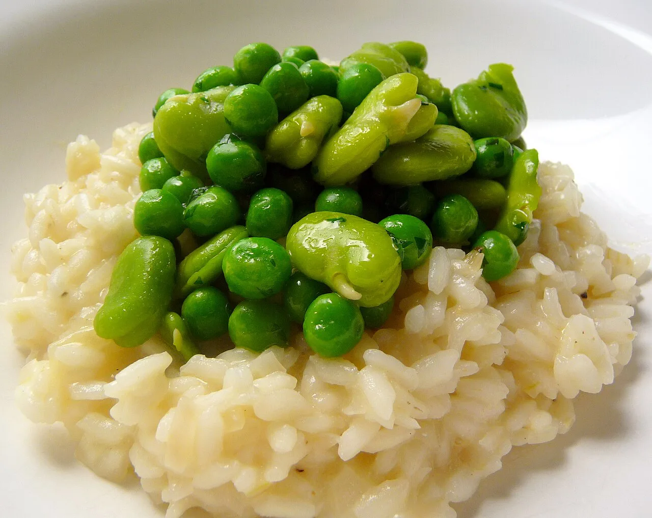 Risotto topped with broad beans and peas.