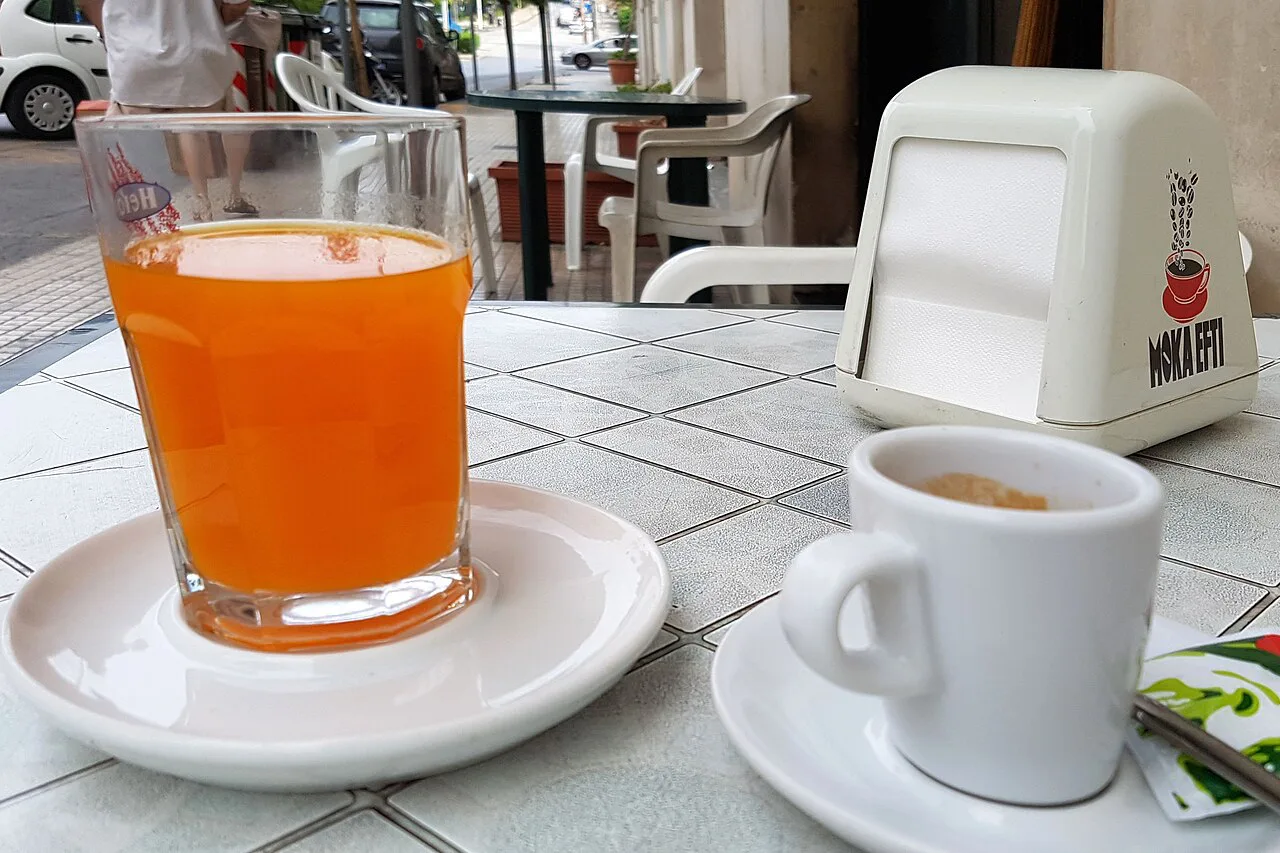 Orange juice and coffee at a café table in Syracuse.