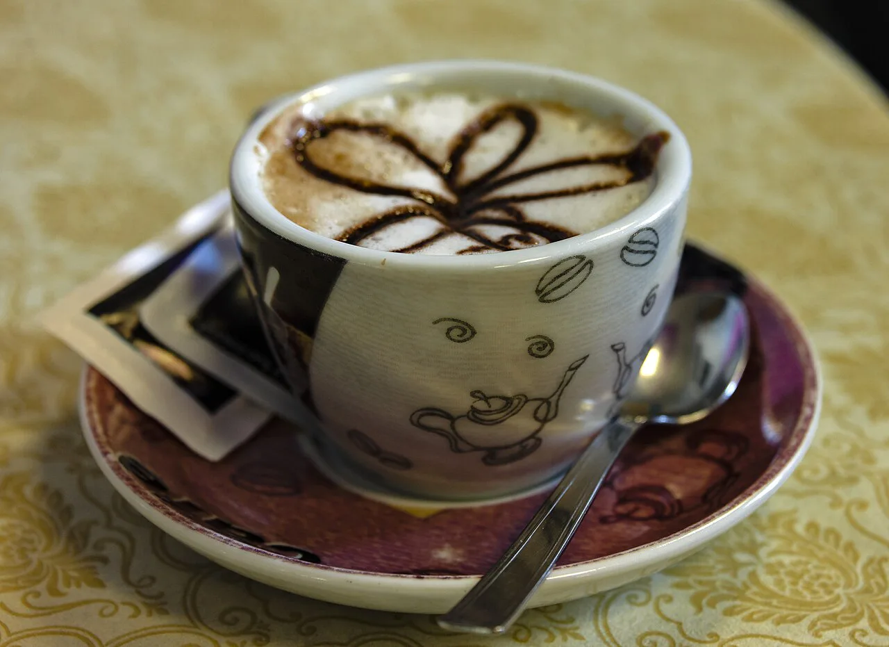 A cappuccino in a decorated cup.