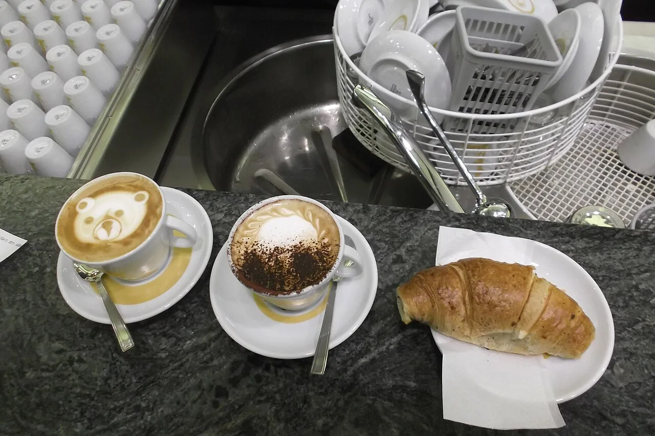 Cappuccinos and a cornetto at a coffee bar in Rome.