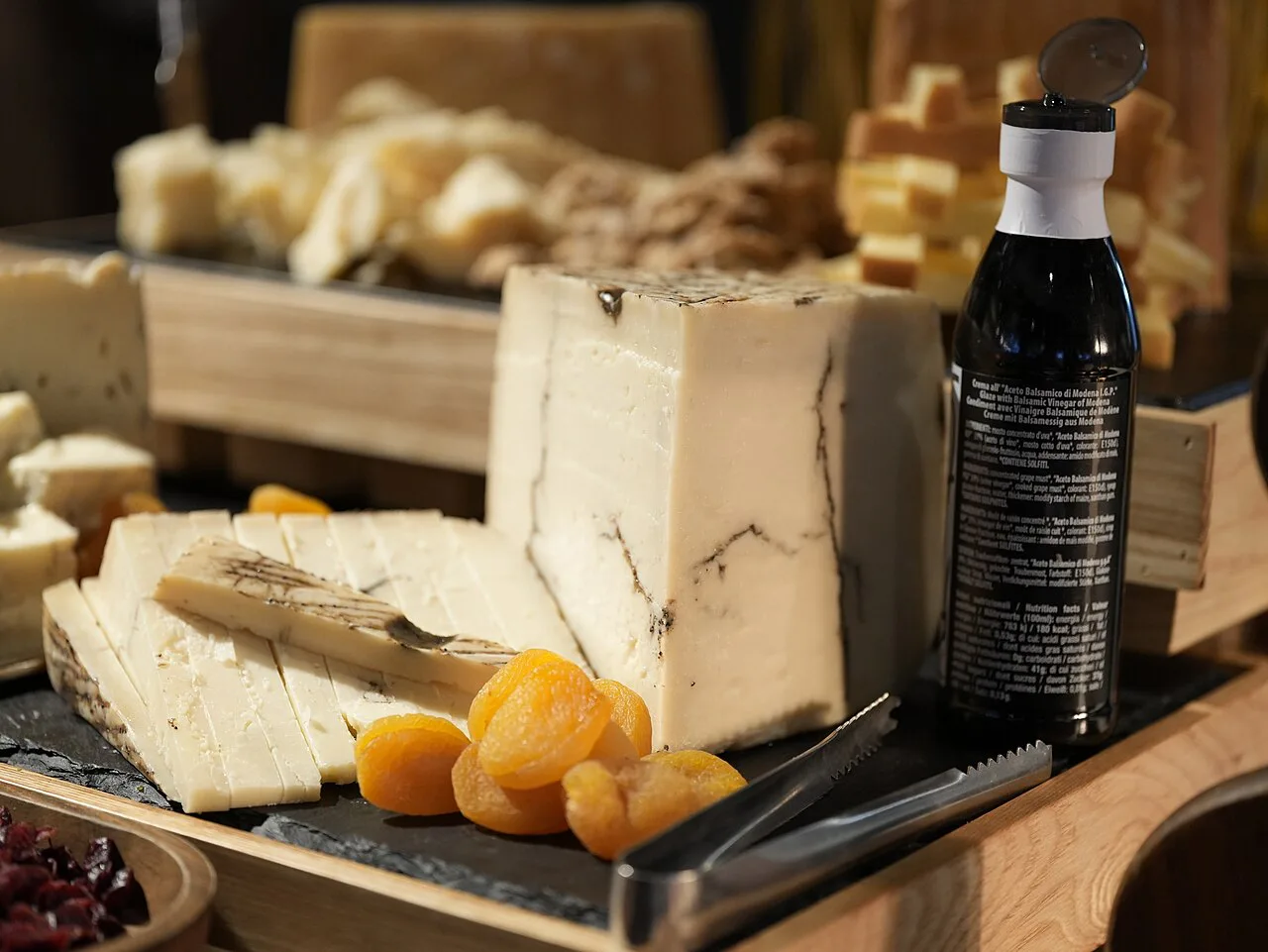 A cheese board with Italian cheeses and dried fruit.