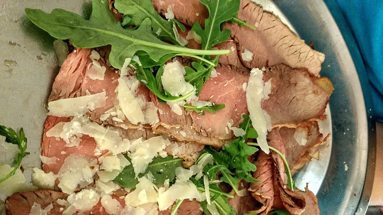 Sliced beef with rocket and shaved Parmesan.