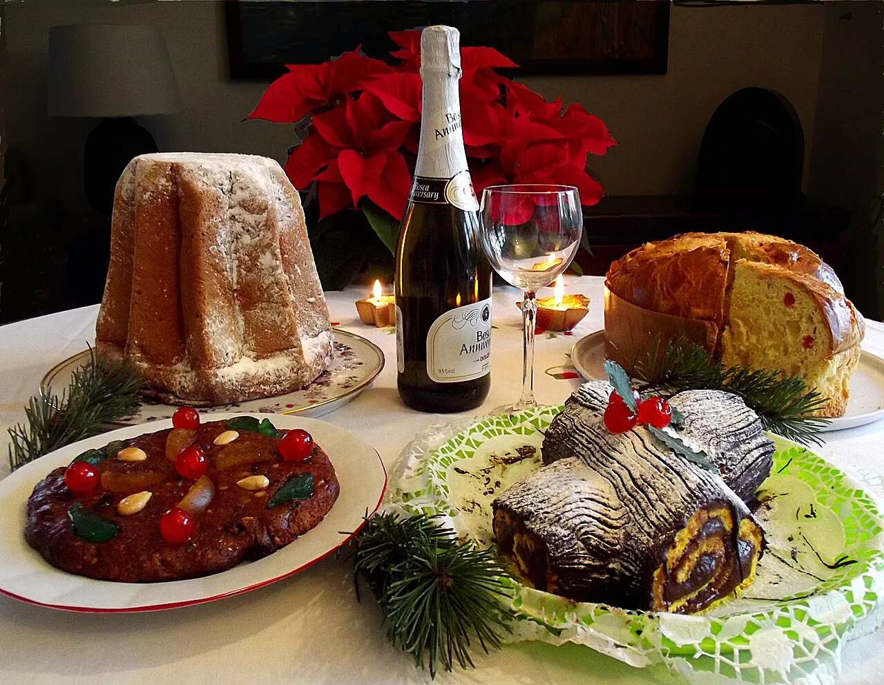 A festive table with panettone and sparkling wine.