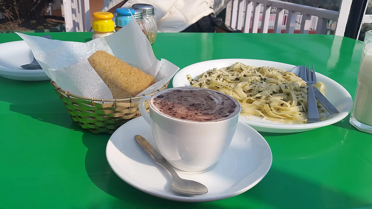 Hot chocolate with bread and pasta at a cafe.