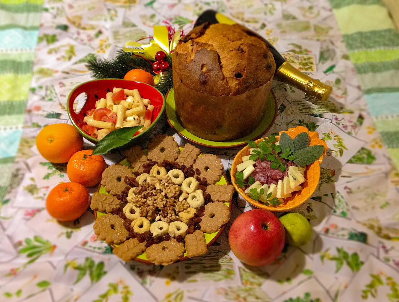 Festive Italian spread of panettone, biscuits and fruit.