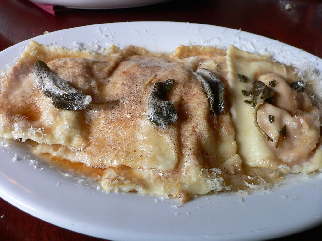 A plate of ravioli with sage butter.