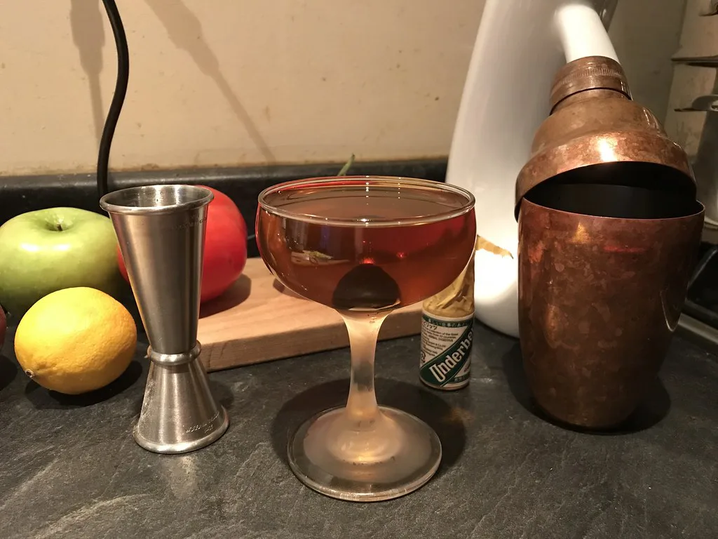 Vermouth cocktail with a jigger and citrus fruit.