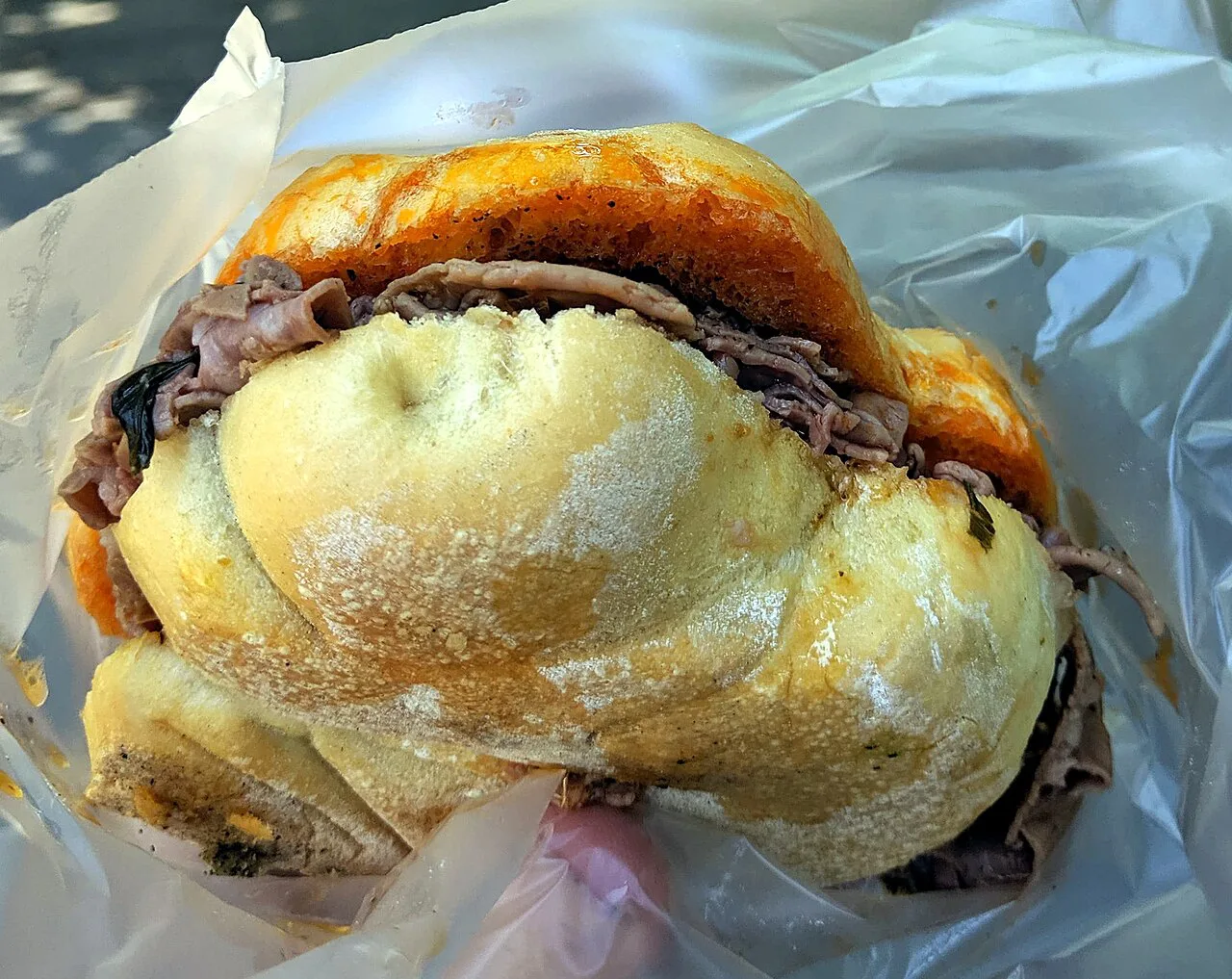A lampredotto sandwich in a crusty roll.