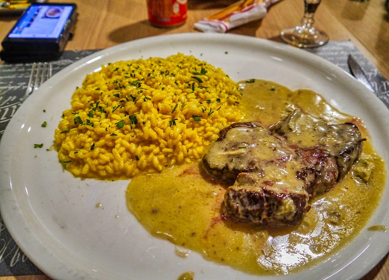 Risotto served with meat on a plate in Varese.