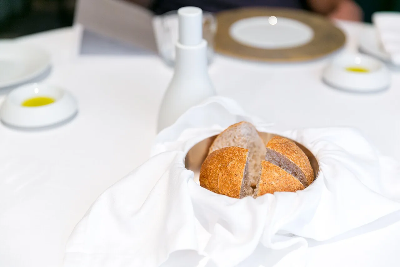 Bread and olive oil laid on a restaurant table.