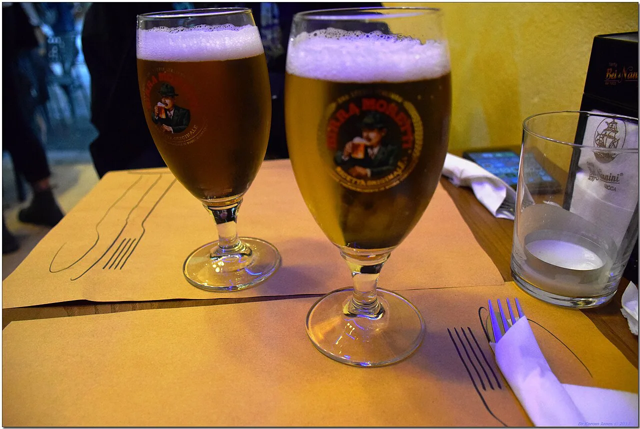 Two beers on a restaurant table in Lucca.