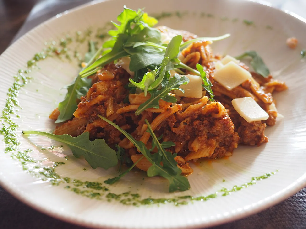 Pasta with meat sauce and fresh herbs.