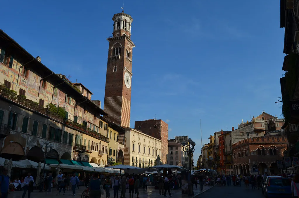 Market stalls and the Torre dei Lamberti in Piazza delle Erbe, Verona.