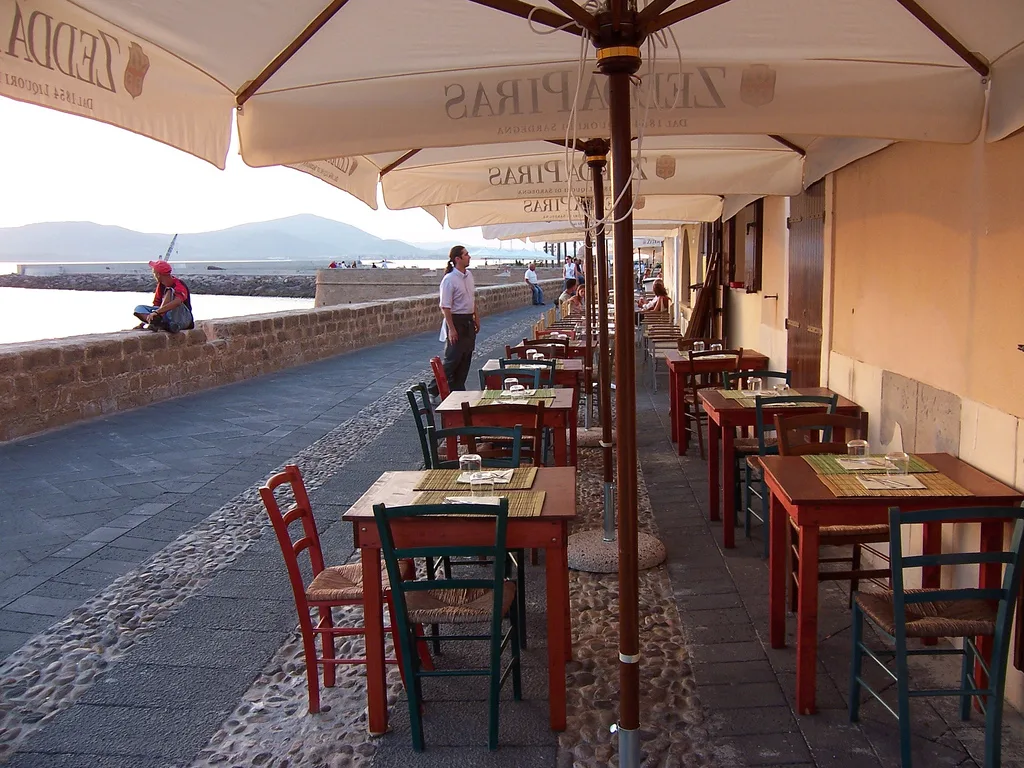 Seafront restaurant tables in Alghero.