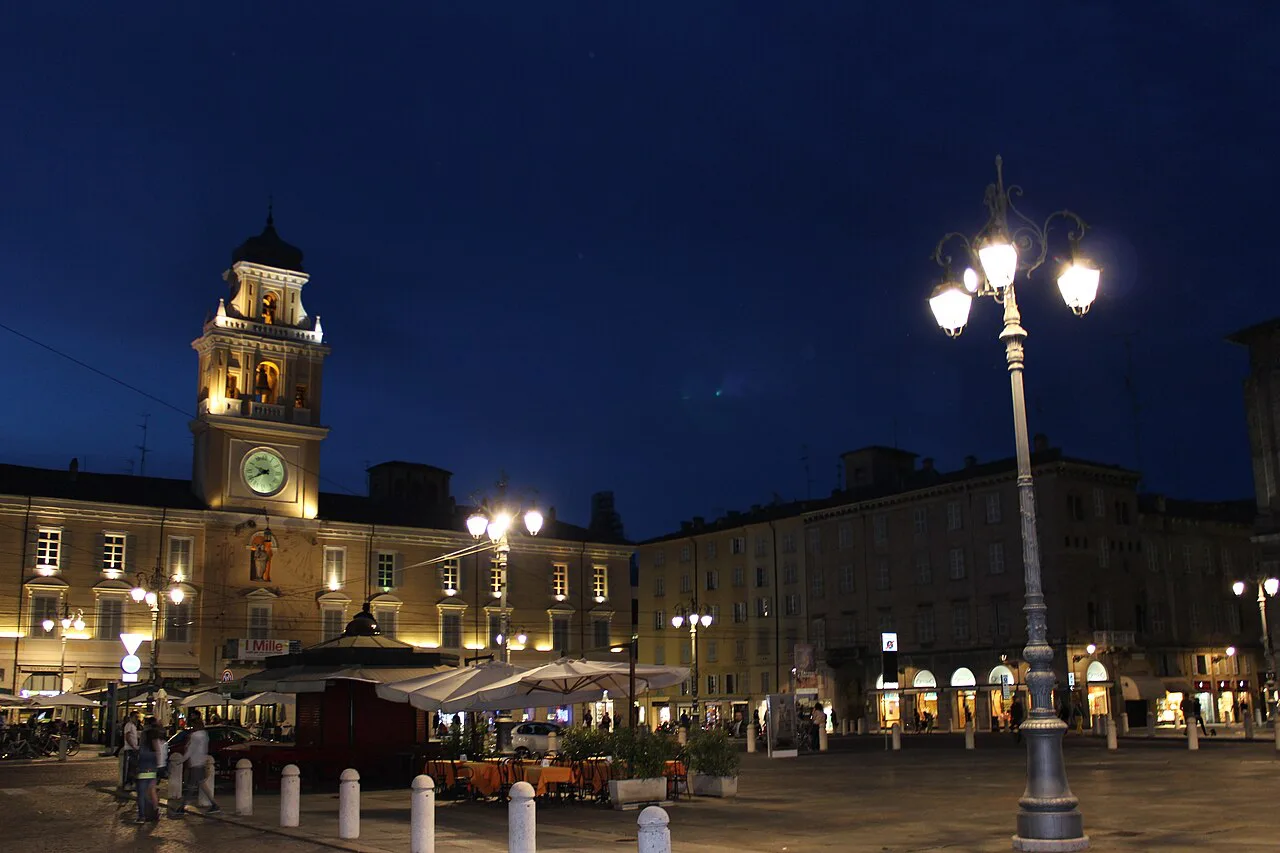Palazzo del Governatore on Piazza Garibaldi, Parma, at dusk.