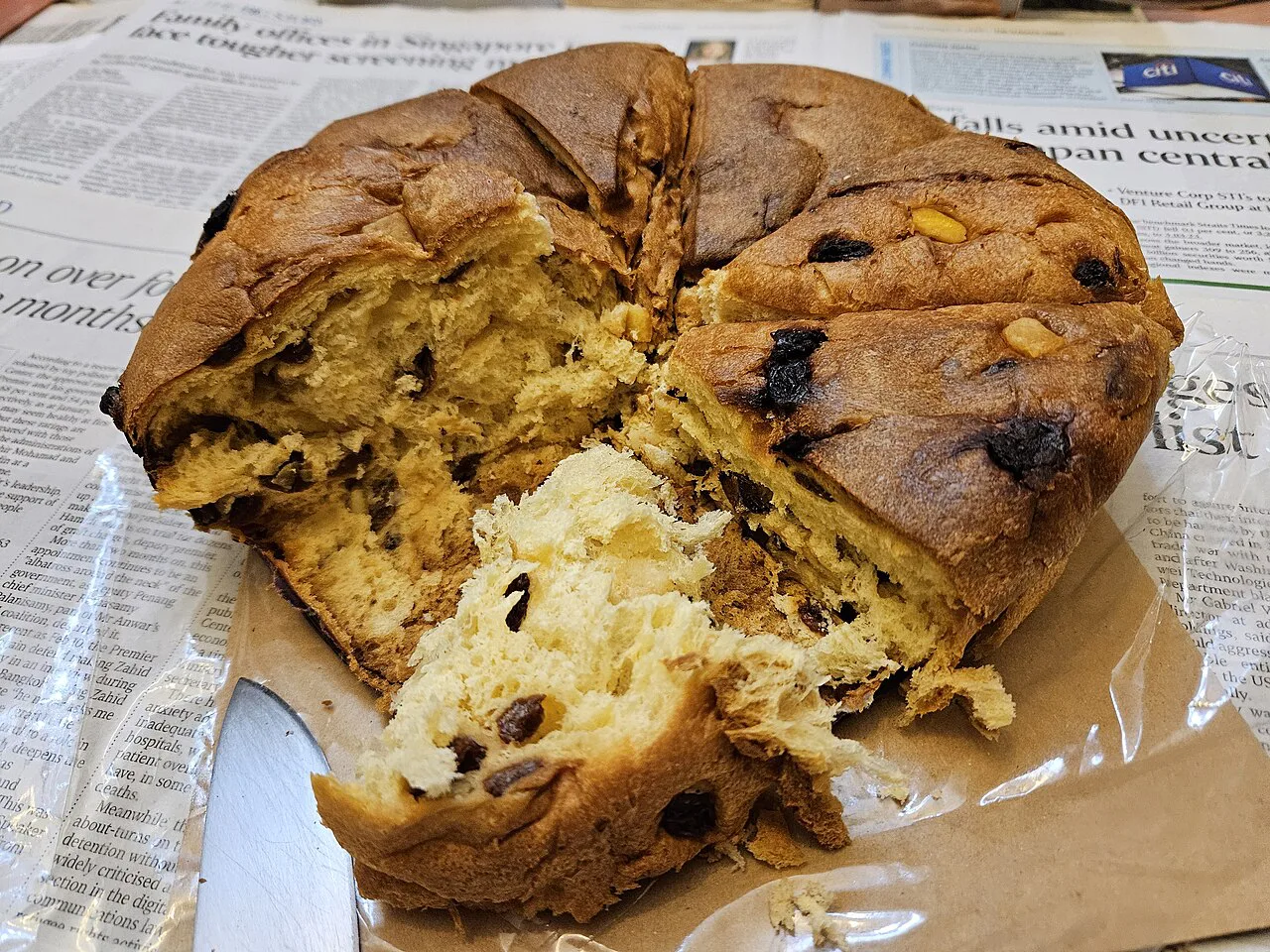 A torn panettone on a sheet of paper.