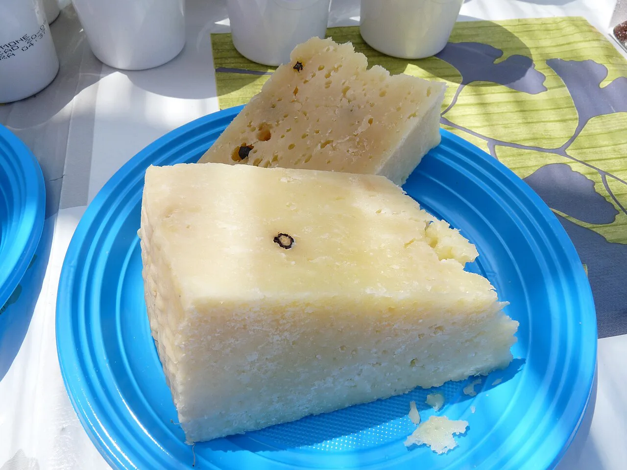 Slices of pecorino cheese on a plate.