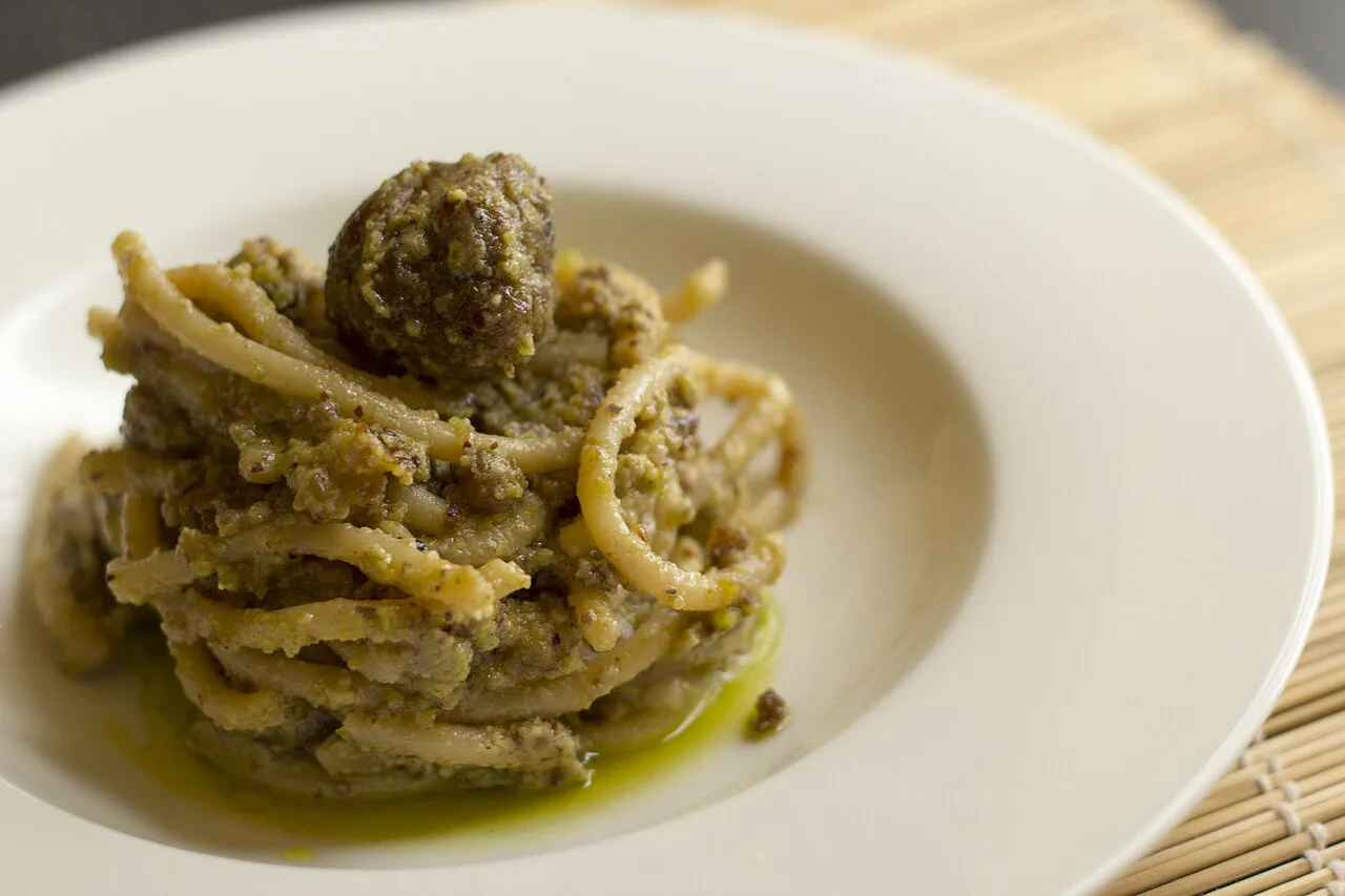 Pici with pistachio pesto and meatballs.