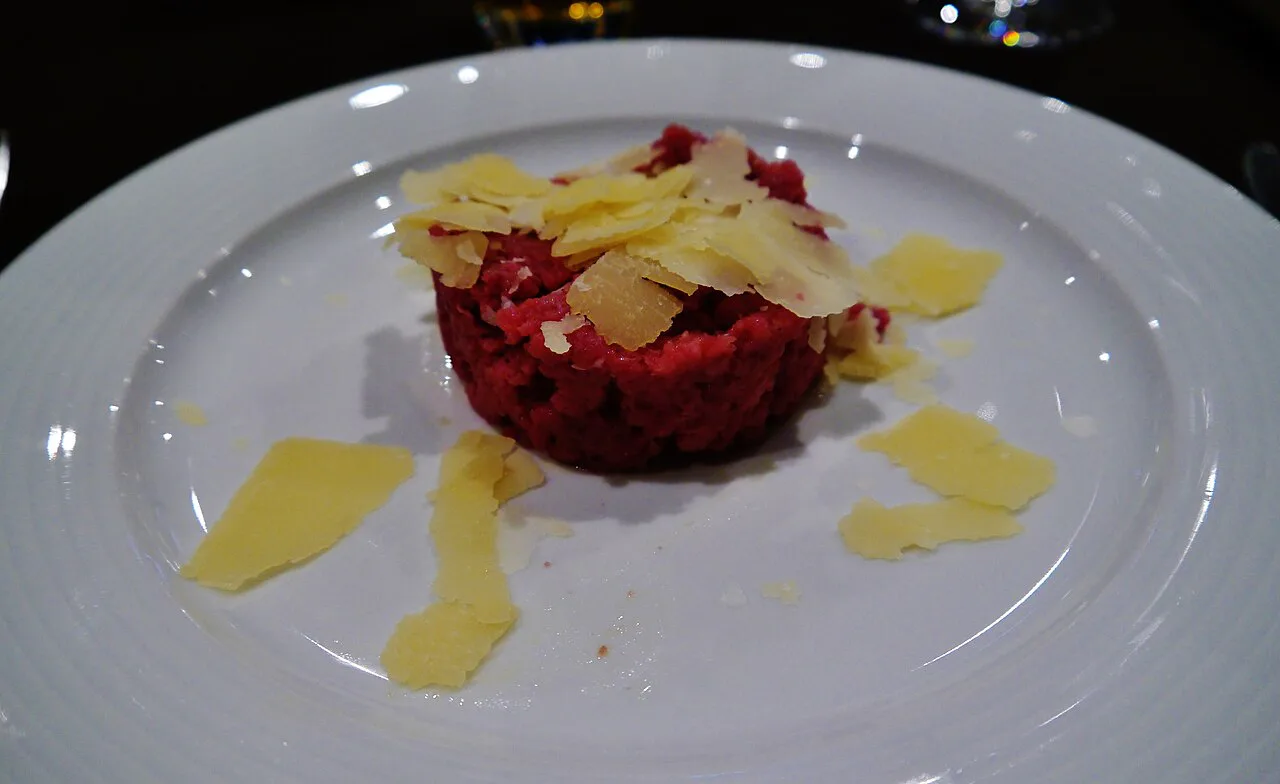 Beef tartare topped with shaved cheese, a Piedmontese dish.