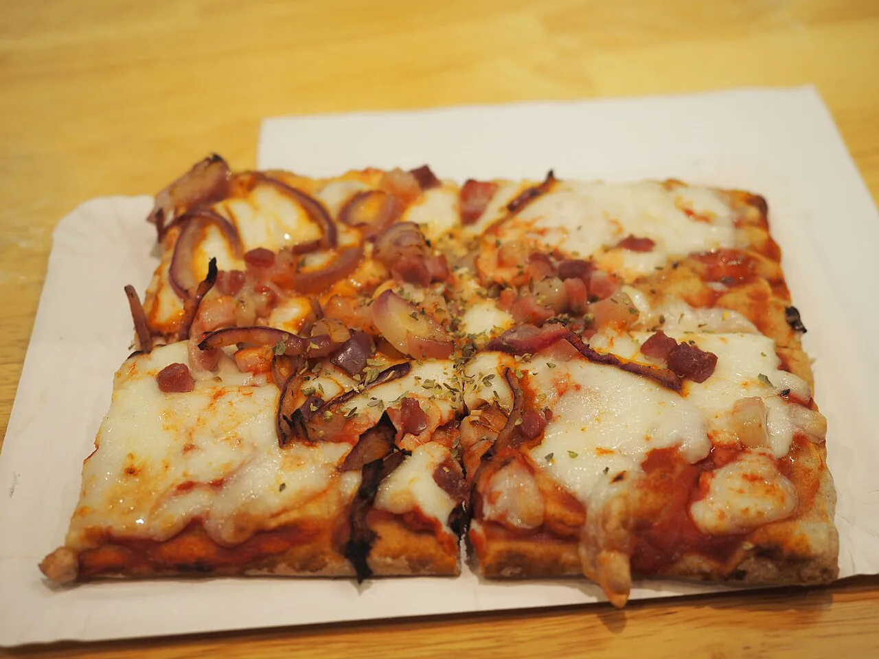 Pizza al taglio with a tomato and cheese topping.