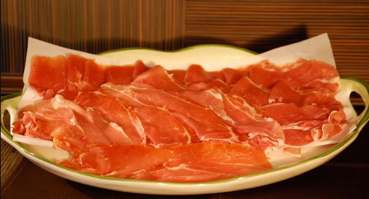 Thinly sliced prosciutto on a plate.