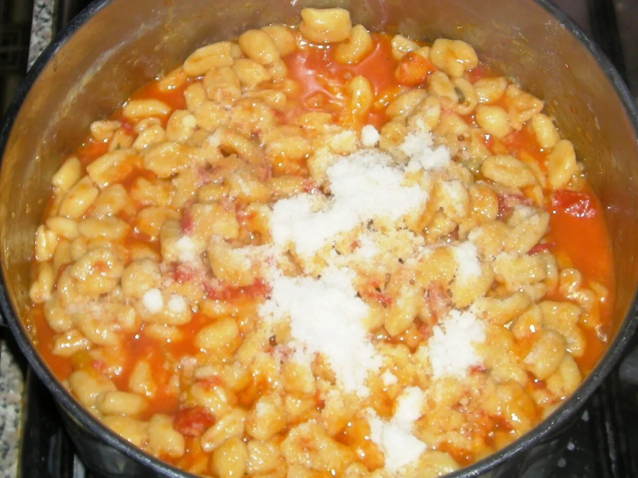 Malloreddus in tomato sauce with grated cheese.