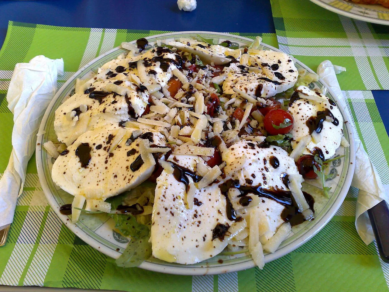 A Sicilian salad with mozzarella and balsamic glaze.