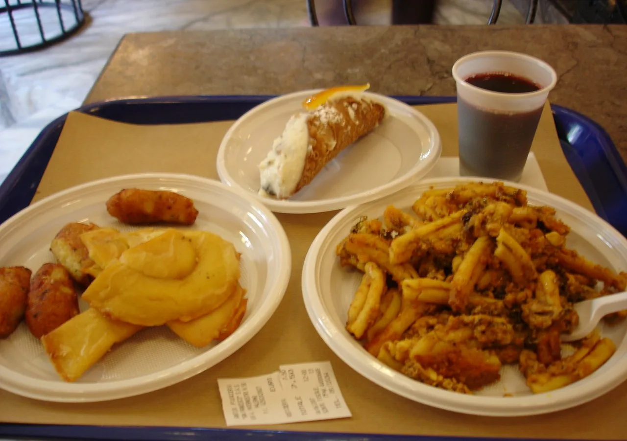 A tray lunch of panelle, cannoli and pasta.