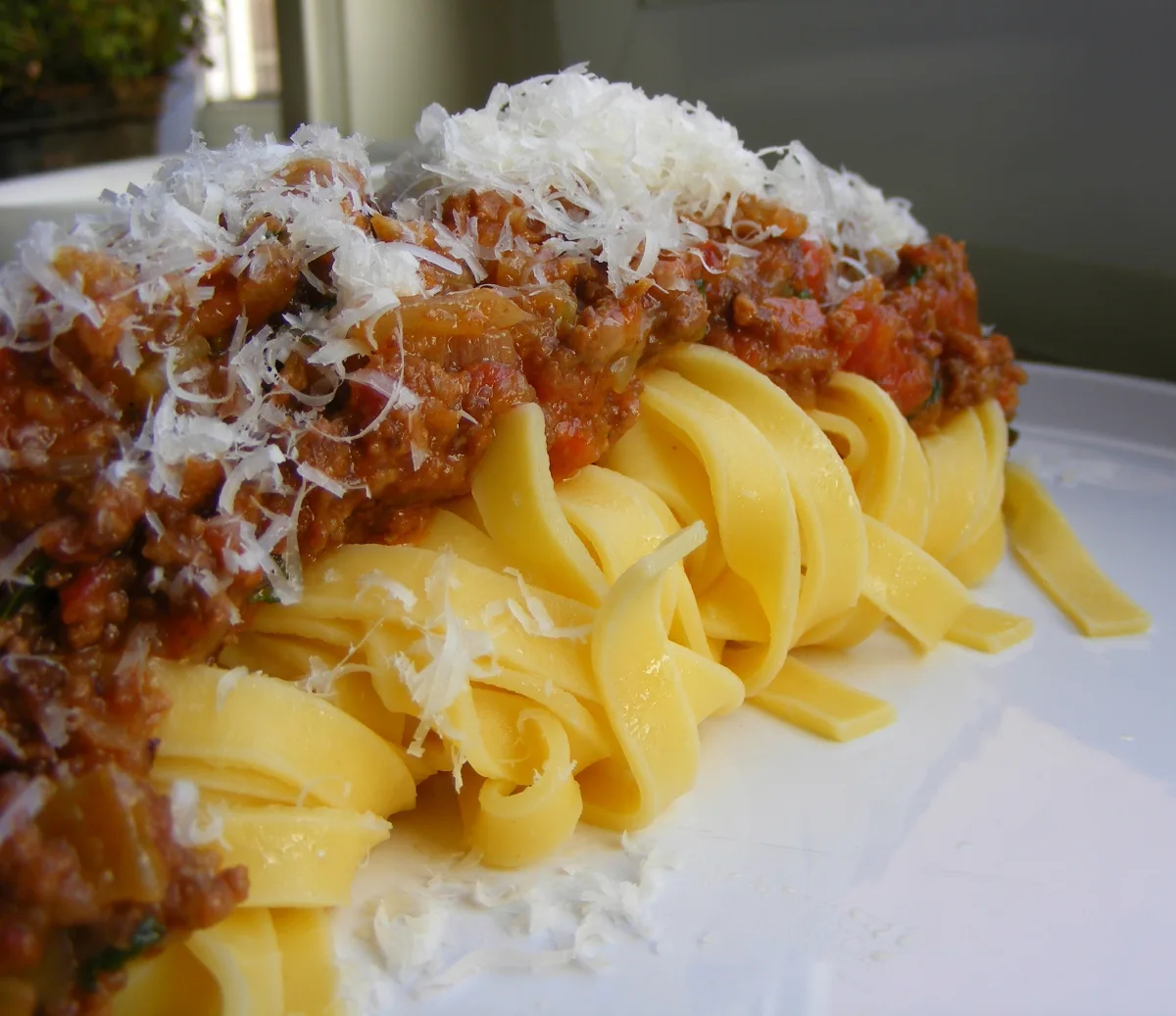 Tagliatelle with ragù and grated cheese.