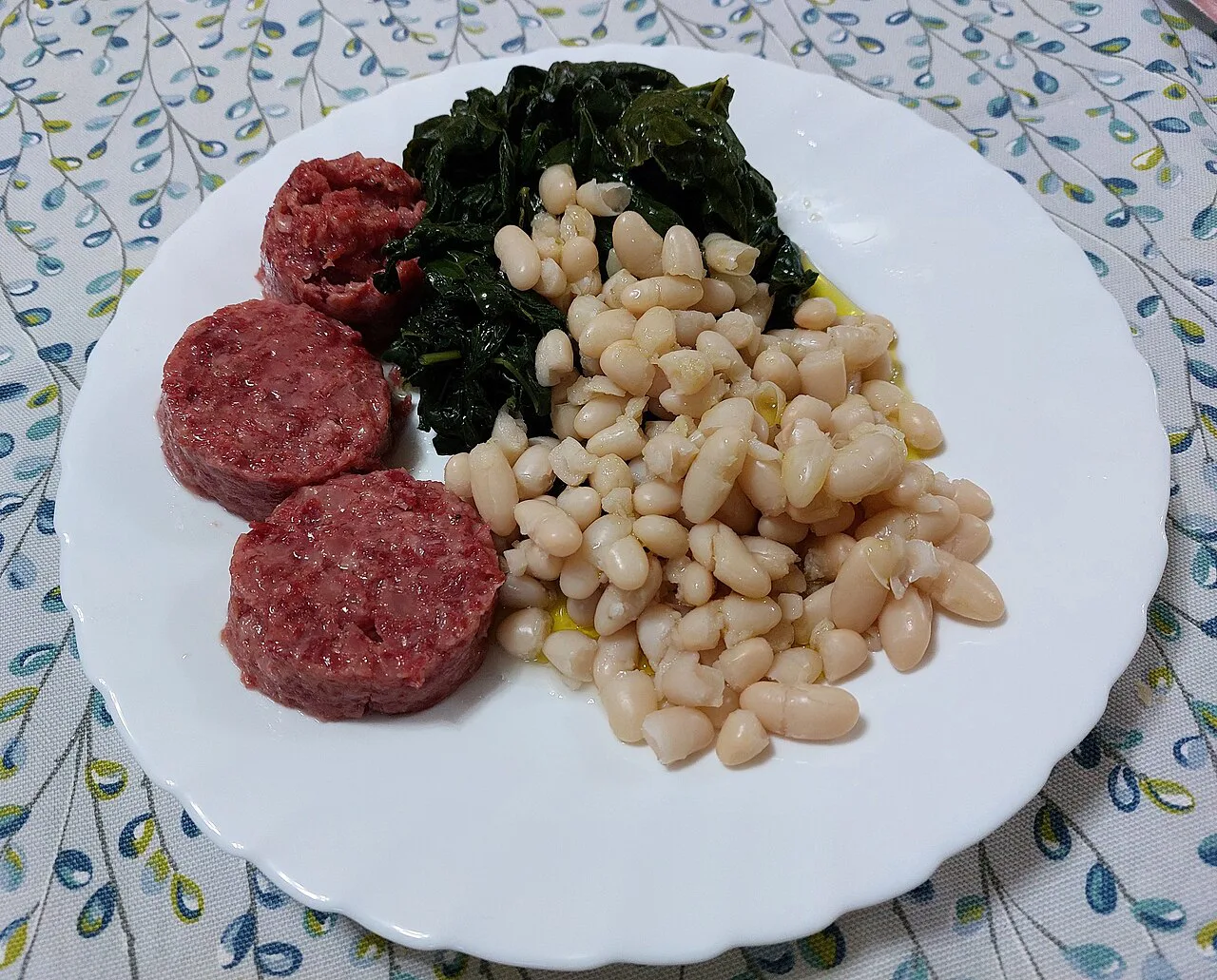 Cotechino with white beans and cavolo nero.