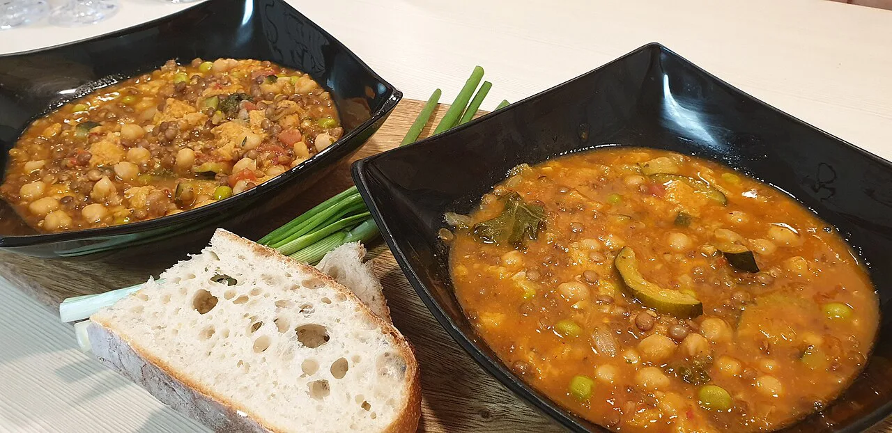 Bowls of ribollita and pulses soup with bread.