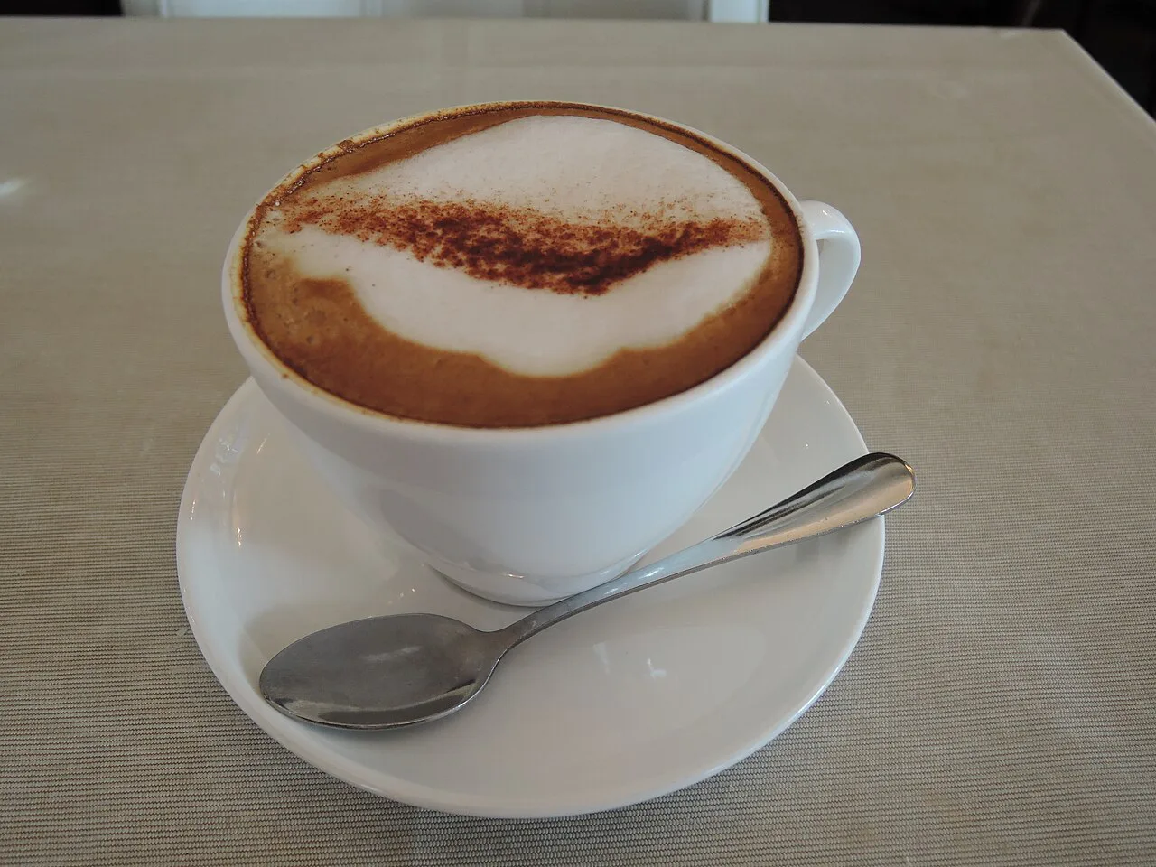 A classic cappuccino on a saucer.
